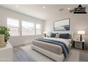 Staged bedroom with a plush bed, large windows, neutral tones, and modern decor for relaxation at 21427 W Meadowbrook Ave, Buckeye, AZ 85396