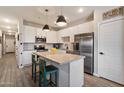 Modern kitchen with white cabinets, stainless steel appliances, and an island with seating at 2753 E Fossil Ridge Rd, Phoenix, AZ 85050