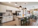 Bright kitchen featuring modern appliances, a central island with seating, and adjacent dining area at 2753 E Fossil Ridge Rd, Phoenix, AZ 85050