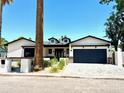Charming single-story home with an attached garage, new landscaping and a view of the blue sky above at 3021 N 47Th St, Phoenix, AZ 85018