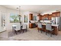 Well-lit eat-in kitchen with stainless steel appliances, island, and wood cabinetry at 31825 N 141St St, Scottsdale, AZ 85262
