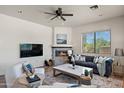 Inviting living room features a cozy fireplace and comfortable seating, perfect for relaxation at 31825 N 141St St, Scottsdale, AZ 85262