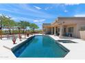 Luxurious pool and spa area featuring manicured landscaping, covered patio, and lounge chairs at 31825 N 141St St, Scottsdale, AZ 85262