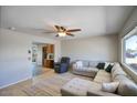 Inviting living room featuring tile floors, a ceiling fan, and a comfortable sectional sofa at 3203 W Libby St, Phoenix, AZ 85053
