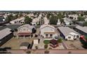 Expansive aerial view of a suburban neighborhood with well-maintained houses and desert landscaping at 3810 N 106Th Dr, Avondale, AZ 85392