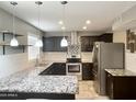 Beautiful kitchen with granite countertops, stainless steel appliances, and custom backsplash at 3810 N 106Th Dr, Avondale, AZ 85392