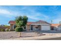 Charming single-story home featuring a red tile roof, xeriscape landscaping, and a two-car garage at 3844 E Shomi St, Phoenix, AZ 85044