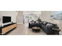 Inviting living room flowing into kitchen area, complete with stylish furnishings and ample natural light at 3844 E Shomi St, Phoenix, AZ 85044