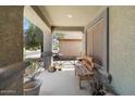Welcoming covered front porch with seating, providing a cozy outdoor space at 5026 S 235Th Dr, Buckeye, AZ 85326