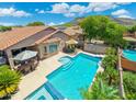 Stunning aerial view showcasing the backyard pool, patio, and lush landscaping with mountain views in the distance at 5123 W Redbird Rd, Phoenix, AZ 85083
