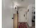 Bright entryway featuring light wood floors, a white front door, and stylish decor at 5216 E Half Moon Dr, Phoenix, AZ 85044