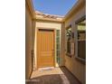 Inviting front entryway with a solid wood door, sidelight windows and brick walkway at 5258 S Verde --, Mesa, AZ 85212
