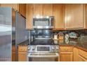 Modern kitchen appliances including stainless steel microwave, stove, and granite countertops at 5303 N 7Th St # 331, Phoenix, AZ 85014