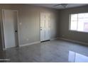 Bright bedroom featuring tile flooring, a ceiling fan, and a large window for natural light at 6702 E Almeria Rd, Scottsdale, AZ 85257