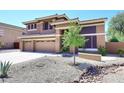 Attractive two-story home featuring a three-car garage and low-maintenance desert landscaping at 6937 W Jackrabbit Ln, Peoria, AZ 85383