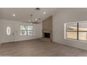 Bright living room with tile flooring, a stone fireplace, and large windows for natural light at 723 E Piute Ave, Phoenix, AZ 85024