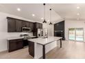 Modern kitchen with white countertops, stainless appliances, and an island in an open floor plan at 862 W Javelina Ave, Mesa, AZ 85210