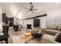 Virtually staged open-concept living room with neutral furniture and a modern ceiling fan at 862 W Javelina Ave, Mesa, AZ 85210