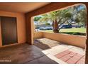 View from covered patio of landscaped yard, trees and parking area at 8940 W Olive Ave # 39, Peoria, AZ 85345