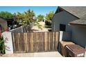 Stylish wooden gate providing privacy and security to the backyard at 10910 N 72Nd Dr, Peoria, AZ 85345