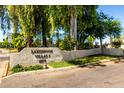 Lakebrook Villas community sign with manicured landscaping and mature trees at 11026 N 28Th Dr # 81, Phoenix, AZ 85029