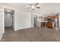 Open-concept living area showcasing tile flooring and seamless transition to a well-appointed kitchen at 11871 W Sherman St, Avondale, AZ 85323