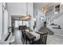 Spacious great room with high ceilings and natural light, adjacent to dining area and staircase at 1359 E 12Th St, Casa Grande, AZ 85122
