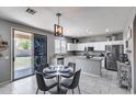 Modern kitchen with stainless appliances and granite island, next to dining area with outdoor access at 1359 E 12Th St, Casa Grande, AZ 85122