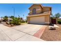 Lovely home with a two-car garage, desert landscaping, and a tile roof at 1403 W Goldfinch Way, Chandler, AZ 85286