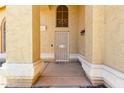 Inviting front porch with security door, stucco pillars and accent lighting at 1403 W Goldfinch Way, Chandler, AZ 85286