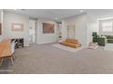 Spacious playroom with neutral walls, soft carpet, and play equipment at 14274 W Sand Hills Rd, Surprise, AZ 85387