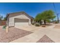 A well-maintained single-story home with a desert landscape, wide driveway, and a two-car garage at 15034 N 30Th St, Phoenix, AZ 85032