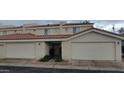 Townhome showcasing attached garages, front door, and desert landscaping creating a welcoming curb appeal at 16021 N 30Th St # 113, Phoenix, AZ 85032