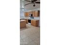 Spacious kitchen with oak cabinets, tile floors, and modern black and white appliances at 16021 N 30Th St # 113, Phoenix, AZ 85032
