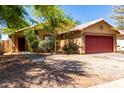 Charming home with low maintenance landscaping, flowering bushes, and a two car garage at 16118 W Morning Glory St, Goodyear, AZ 85338
