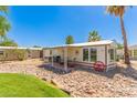 Charming home featuring rock landscaping and a covered front patio with furniture at 17200 W Bell Rd # 2189, Surprise, AZ 85374