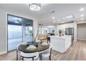 Open-concept dining area adjacent to kitchen with sliding glass door to outdoor patio at 17911 N Adobe Mesa Ct, Surprise, AZ 85374