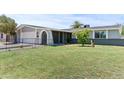Well-kept single-story home featuring a lush green lawn and charming curb appeal at 2106 W 8Th Ave, Mesa, AZ 85202