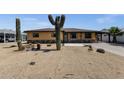Single story home featuring a low maintenance desert landscape, covered parking, and desert flora at 2118 W Cactus Wren Dr, Phoenix, AZ 85021