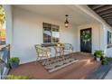 Inviting front porch with seating, potted plants, and a decorative wreath on the front door at 2520 N 15Th St, Phoenix, AZ 85006