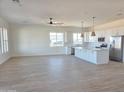 Spacious open concept living and kitchen area, featuring hard wood flooring and ample natural light at 28151 N Faded Creek Dr, Florence, AZ 85132