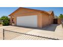 View of tan-colored single Gathering house, showing attached two-car garage and wide driveway at 3507 W Oakland St, Chandler, AZ 85226