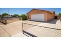 View of tan-colored single Gathering house, showing attached two-car garage and wide driveway at 3507 W Oakland St, Chandler, AZ 85226