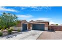 Charming home featuring a three car garage and neutral color palette at 37460 W Giallo Ln, Maricopa, AZ 85138