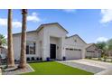 Beautiful single-story home with a well-maintained yard, prominent palm tree, and modern design elements at 389 W Fairway Pl, Chandler, AZ 85225