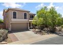 Two-story home boasts a two-car garage and desert landscaping, providing an inviting curb appeal at 43813 W Rio Lobo Dr, Maricopa, AZ 85138