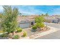 Aerial view of a single-story home with a neutral color palette, landscaped yard, and a two-car garage at 46068 W Guilder Ave, Maricopa, AZ 85139