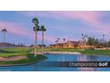 Scenic golf course view with a lake, sand traps, and palm trees against a beautiful sky at 5775 N Oak Creek Dr, Eloy, AZ 85131