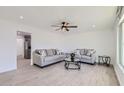 Bright living room with tile floors, neutral paint, ceiling fan and comfortable seating arrangement at 5827 N 22Nd Dr, Phoenix, AZ 85015
