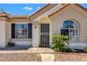 Close-up of front entrance with security door, arched window and desert landscaping at 823 W Kyle Ct, Gilbert, AZ 85233